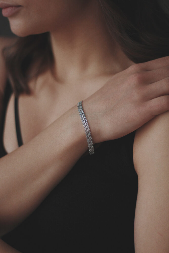 Silver bracelet worn by a female jewelry model